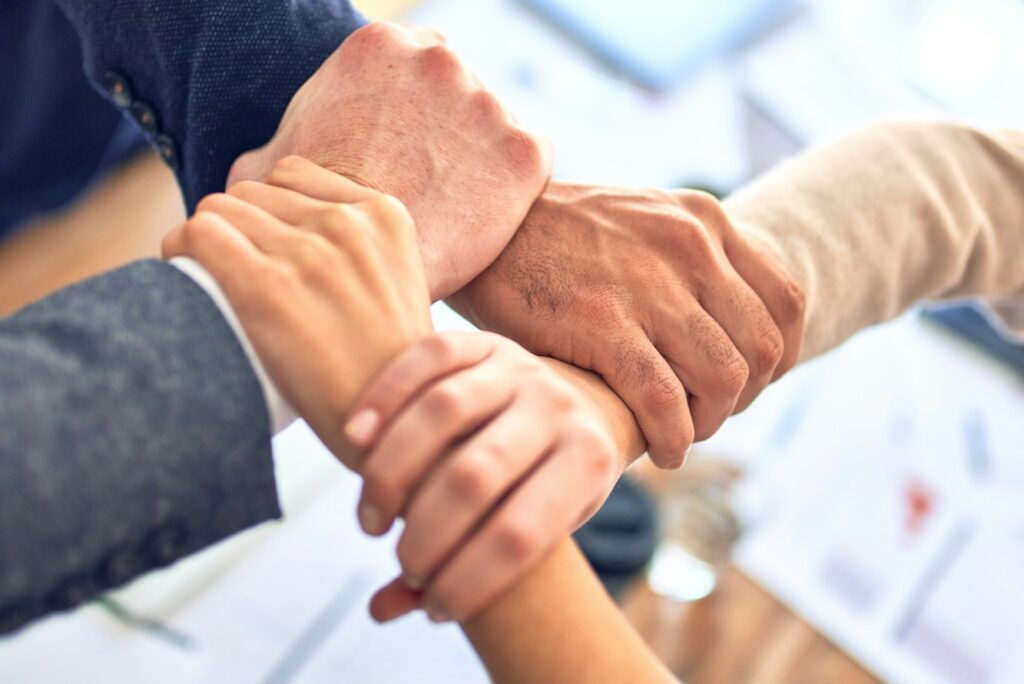 person in black long sleeve shirt holding persons hand