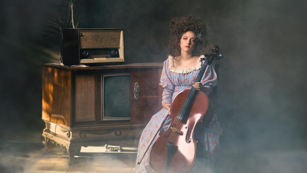 a woman sitting in a chair with a violin